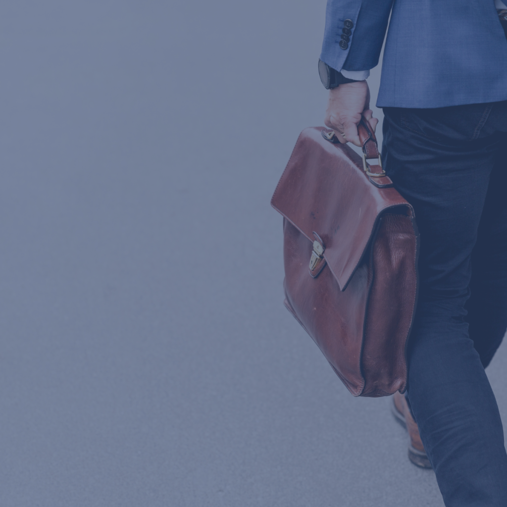 Men walking to the office with a laptop bag, he is a SOC 2 consultant